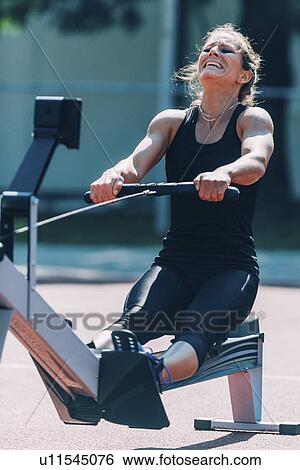 Stock Photograph - Rowing machine workout. Fotosearch