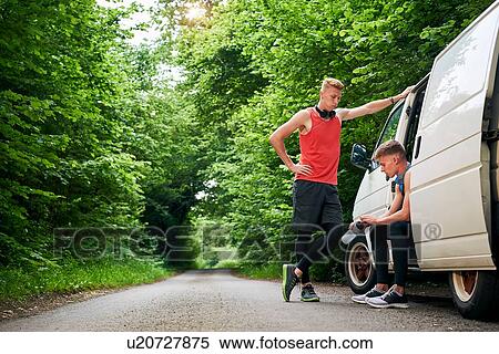Runner friends talking beside van View Large Photo Image Stock Photography - Runner friends talking beside van. Fotosearch