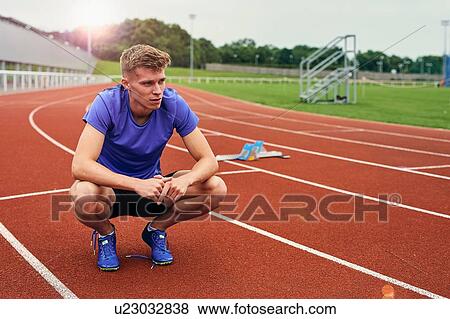 Runner resting on running track View Large Photo Image Stock Photo - Runner resting on running track. Fotosearch