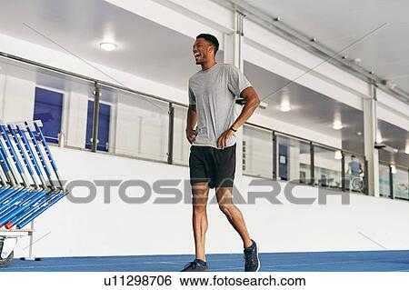 Runner training on indoor running track View Large Photo Image Stock Photograph - Runner training on indoor running track. Fotosearch