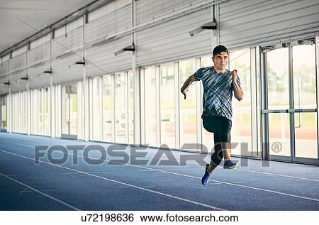 Runner training on indoor running track View Large Photo Image Stock Photograph - Runner training on indoor running track. Fotosearch