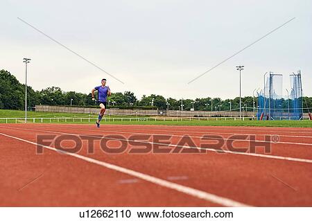 Stock Image - Runner training on running track. Fotosearch