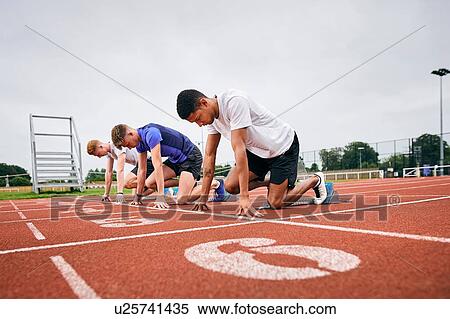 Stock Photography - Runners at starting line on running track. Fotosearch