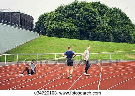 Runners resting on running track View Large Photo Image Stock Image - Runners resting on running track. Fotosearch
