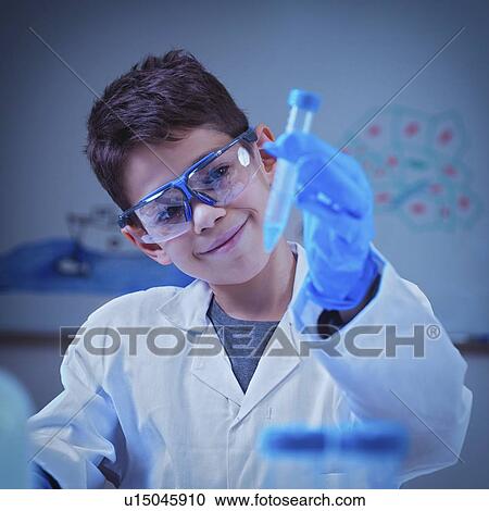 Stock Image - Schoolboy doing chemistry experiment. Fotosearch