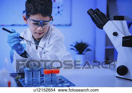 Picture - Schoolboy doing science experiment. Fotosearch