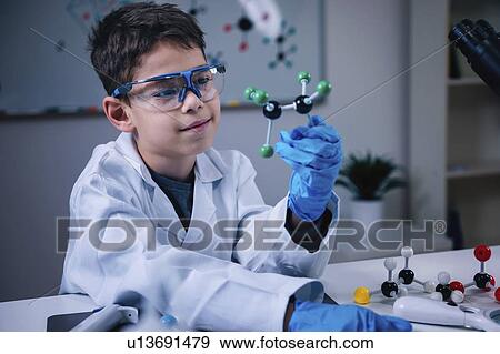 Schoolboy holding molecular model View Large Photo Image Stock Photo - Schoolboy holding molecular model. Fotosearch