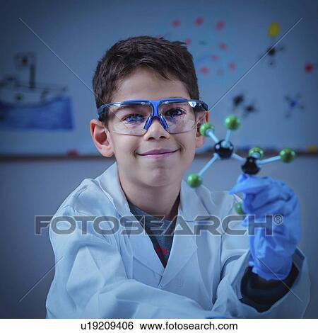 Stock Photograph - Schoolboy holding molecular model. Fotosearch