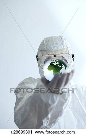 Scientist in protective clothing holding globe in his hand. View Large Photo Image Stock Image - Scientist in protective clothing holding globe in his hand.. Fotosearch