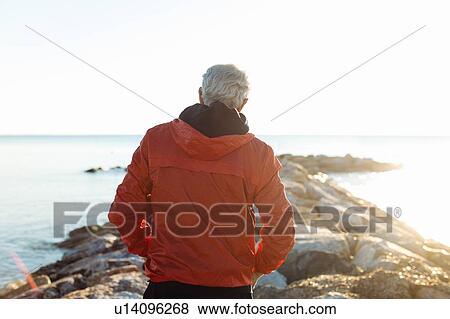 Senior man watching sunset on beach, Livorno, Italy View Large Photo Image Stock Photo - Senior man watching sunset on beach, Livorno, Italy. Fotosearch