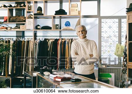 Picture - Senior man working in clothes shop. Fotosearch