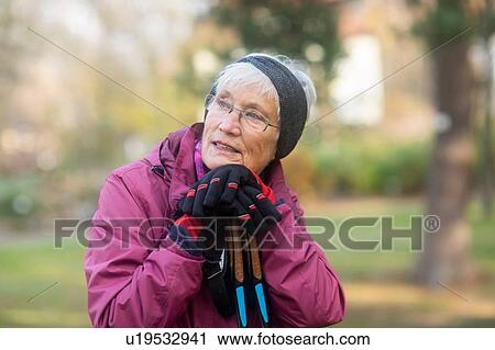Senior woman resting from walk in park View Large Photo Image Stock Image - Senior woman resting from walk in park. Fotosearch