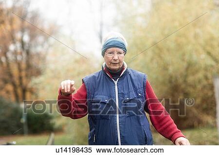 Senior woman walking in park View Large Photo Image Stock Photography - Senior woman walking in park. Fotosearch