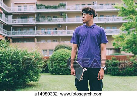 Skateboarder posing with skateboard, Milan, Italy View Large Photo Image Stock Image - Skateboarder posing with skateboard, Milan, Italy. Fotosearch