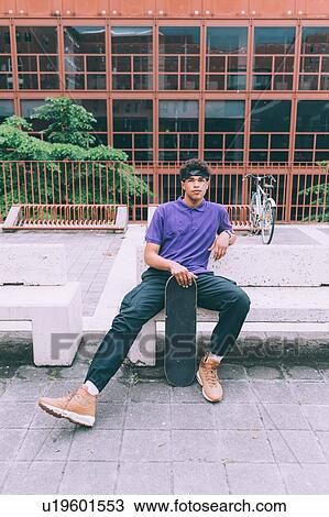 Skateboarder posing with skateboard, Milan, Italy View Large Photo Image Stock Image - Skateboarder posing with skateboard, Milan, Italy. Fotosearch