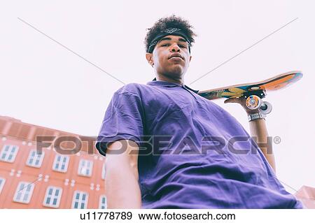 Skateboarder posing with skateboard, Milan, Italy View Large Photo Image Stock Photo - Skateboarder posing with skateboard, Milan, Italy. Fotosearch