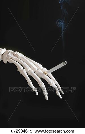 Stock Photography - Skeleton smoking. Fotosearch