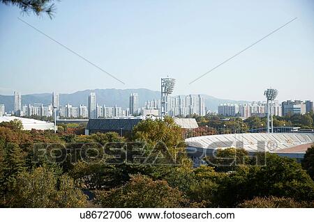 Skyline in daytime, national park and sports stadium in foreground, Seoul, South Korea View Large Photo Image Stock Photograph - Skyline in daytime, national park and sports stadium in foreground, Seoul, South Korea. Fotosearch