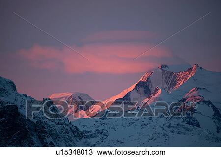 Stock Image - Snow covered alps at sunset, Zermatt, Valais, Switzerland. Fotosearch