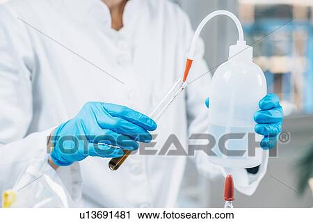 Soil testing. Female biologist in white coat pouring water into test tube with dissolved samples of soil in laboratory. Agrochemical examination of soil. View Large Photo Image Stock Image - Soil testing. Female biologist in white coat pouring water into test tube with dissolved samples of soil in laboratory. Agrochemical examination of soil.. Fotosearch