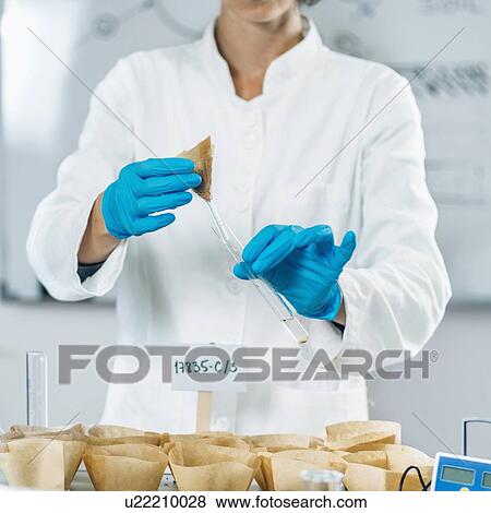Soil testing laboratory. Female biologist in white coat pouring water in soil sample. View Large Photo Image Stock Photo - Soil testing laboratory. Female biologist in white coat pouring water in soil sample.. Fotosearch