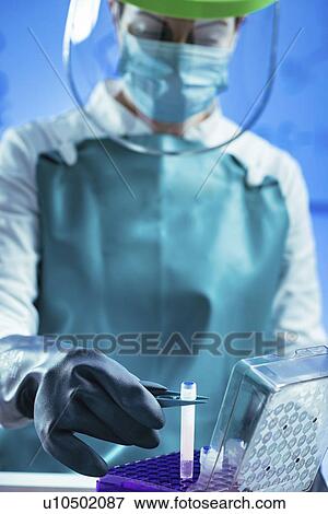 Stock Photo - Technician preparing biological sample for deep freezing. Fotosearch