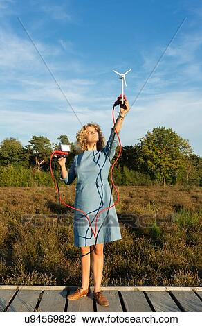 Teenage girl powering LED light using miniature wind turbine, Netherlands View Large Photo Image Stock Photo - Teenage girl powering LED light using miniature wind turbine, Netherlands. Fotosearch