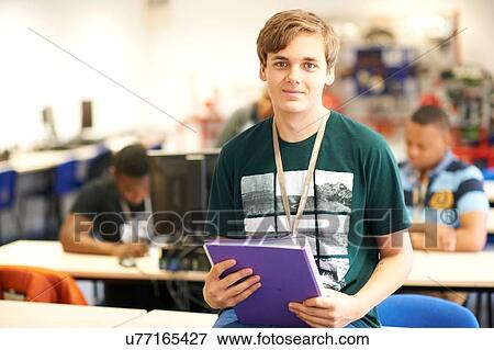 Teenage male higher education student in college classroom, portrait View Large Photo Image Stock Photo - Teenage male higher education student in college classroom, portrait. Fotosearch