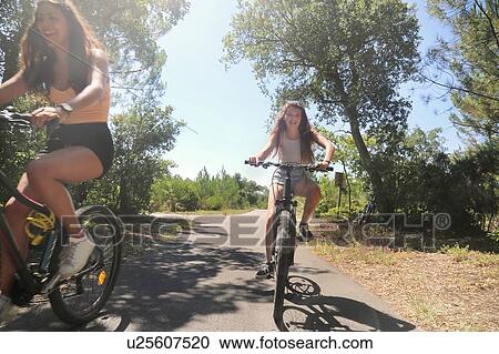 Teenagers cycling on countryside road, Aquitaine, France View Large Photo Image Stock Image - Teenagers cycling on countryside road, Aquitaine, France. Fotosearch