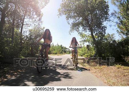Teenagers cycling on countryside road, Aquitaine, France View Large Photo Image Stock Photo - Teenagers cycling on countryside road, Aquitaine, France. Fotosearch