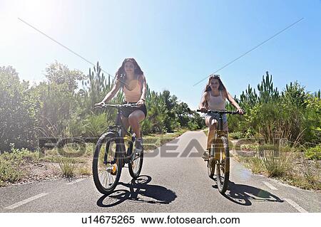 Teenagers cycling on countryside road, Aquitaine, France View Large Photo Image Stock Photography - Teenagers cycling on countryside road, Aquitaine, France. Fotosearch