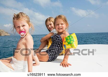 Three cute girls sitting on boat, portrait, Castellammare del Golfo, Sicily, Italy View Large Photo Image Stock Image - Three cute girls sitting on boat, portrait, Castellammare del Golfo, Sicily, Italy. Fotosearch