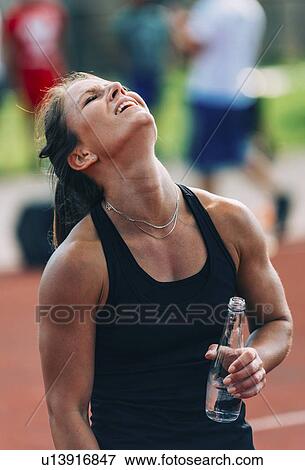 Stock Photo - Tired woman after workout. Fotosearch