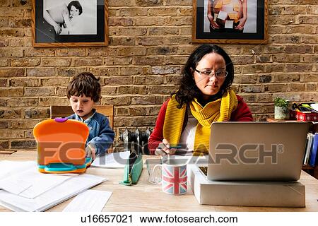 Toddler boy learning from mother working from home View Large Photo Image Stock Image - Toddler boy learning from mother working from home. Fotosearch