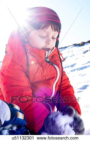 Stock Image - Toddler boy playing in snow, Piani Resinelli, Lombardy, Italy. Fotosearch
