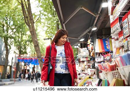 Stock Photograph - Tourist browsing souvenirs in city, Seoul, South Korea. Fotosearch