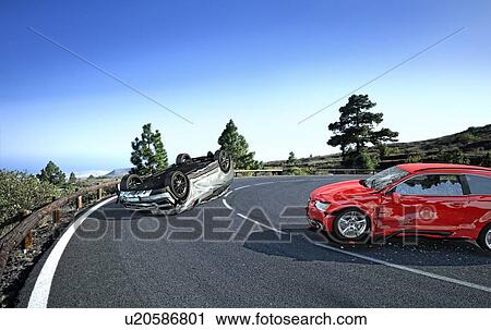 Stock Image - Two cars accident. Crashed cars on a road in the country side location. A red sedan against a silver car upside down. Strong collision with big damages.. Fotosearch