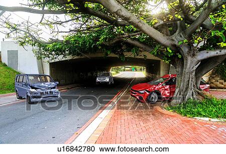 Two cars accident. Crashed cars on the road on location. A red sedan against a tree after collision with a grey van. View Large Photo Image Stock Image - Two cars accident. Crashed cars on the road on location. A red sedan against a tree after collision with a grey van.. Fotosearch