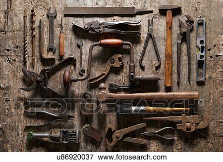 Stock Photo - Variety of vintage hand tools on wood, overhead view. Fotosearch