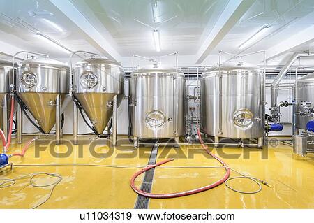Stock Photo - View of brewing tanks in small brewery. Fotosearch
