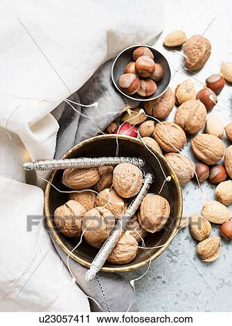 Stock Image - Walnuts and almonds in shell, hazelnuts, ornaments. Fotosearch