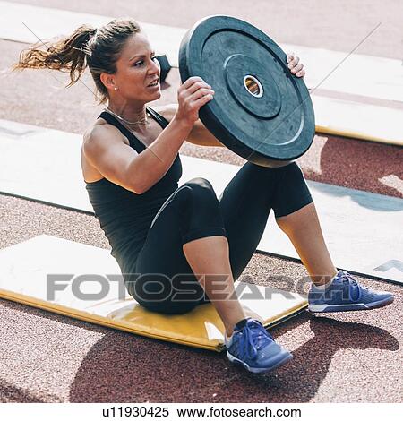 Stock Photography - Weighted sit ups. Fotosearch