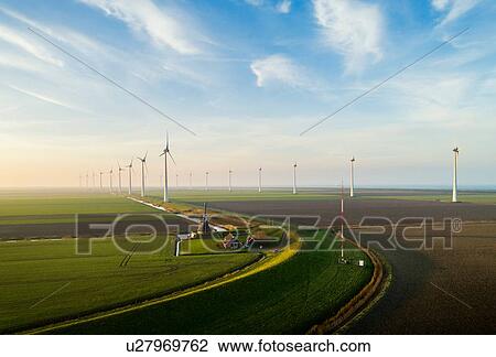 Wind turbines with traditional windmill in foreground, Eemshaven harbour, Groningen, Netherlands View Large Photo Image Stock Image - Wind turbines with traditional windmill in foreground, Eemshaven harbour, Groningen, Netherlands. Fotosearch