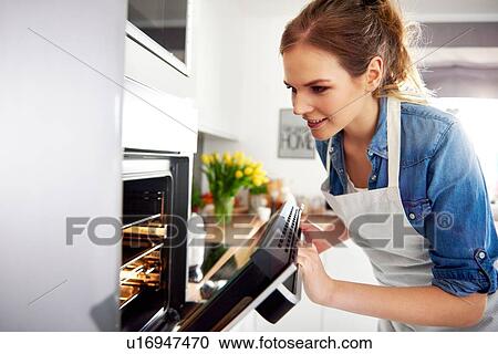 Stock Image - Woman baking in kitchen. Fotosearch