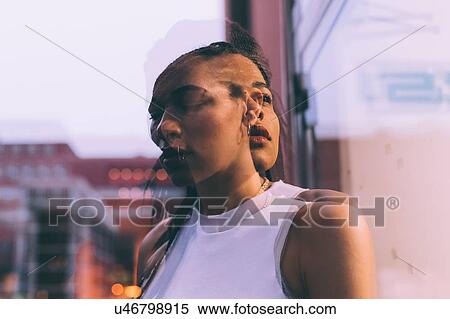 Woman beside glass window View Large Photo Image Stock Photography - Woman beside glass window. Fotosearch