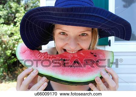 Woman biting into watermelon View Large Photo Image Stock Image - Woman biting into watermelon. Fotosearch