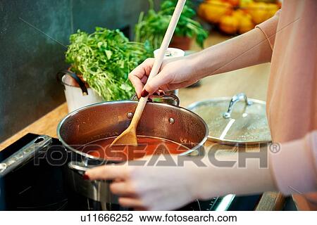 Woman cooking tomato soup in kitchen View Large Photo Image Stock Image - Woman cooking tomato soup in kitchen. Fotosearch