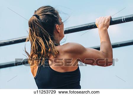 Woman doing pull ups View Large Photo Image Stock Photo - Woman doing pull ups. Fotosearch