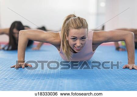 Stock Photograph - Woman doing push up. Fotosearch