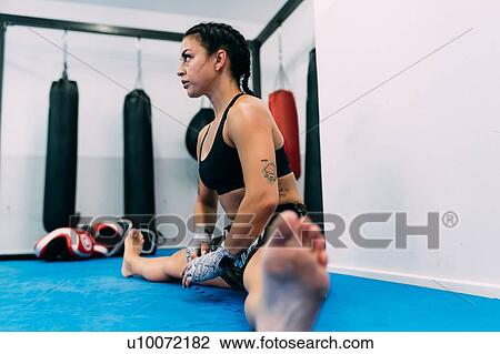 Woman doing stretching exercises in gym View Large Photo Image Stock Image - Woman doing stretching exercises in gym. Fotosearch